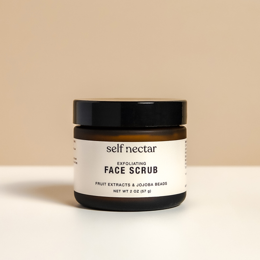An exfoliating face scrub presented in an elegant container on a neutral-colored surface. The product is labeled as an exfoliating face scrub, showcasing a clean and minimalist design for effective and rejuvenating skincare.
