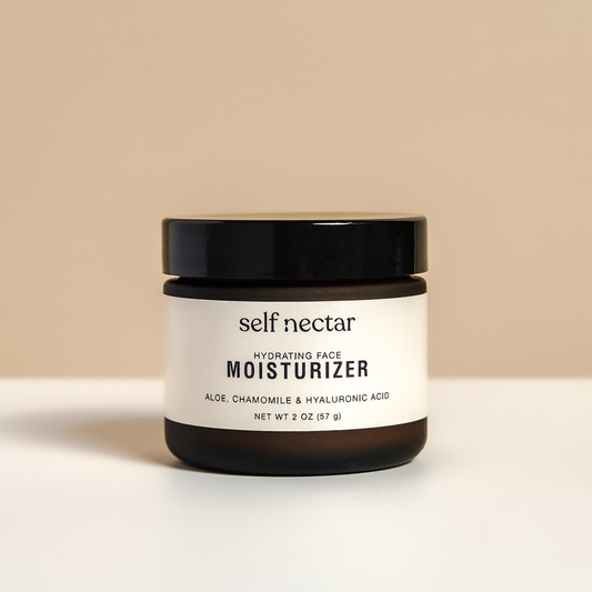 A hydrating face moisturizer in an amber container placed on a neutral-colored surface. The product is labeled as a hydrating face moisturizer, showcasing a clean and minimalist skincare design.
